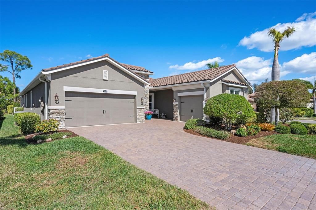 11550 Tapestry Lane Venice, FL 34293 - Photo 1 of 1 a front view of a house with a yard and garage