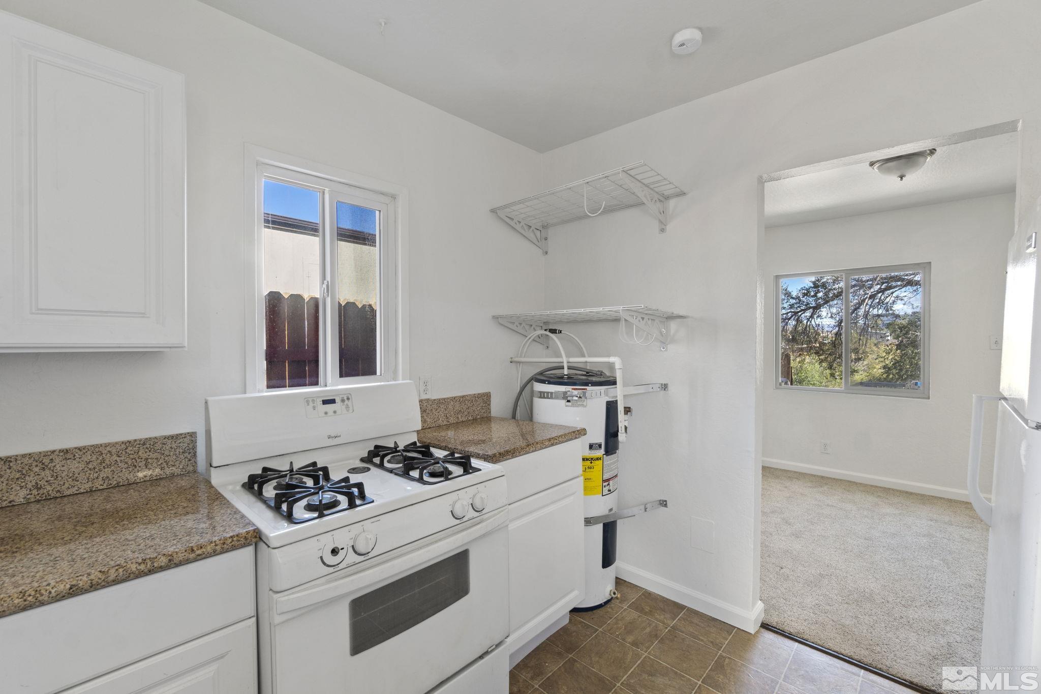 157 Walner Street Reno, NV 89506 - Photo 11 of 21 a kitchen with a stove and a refrigerator