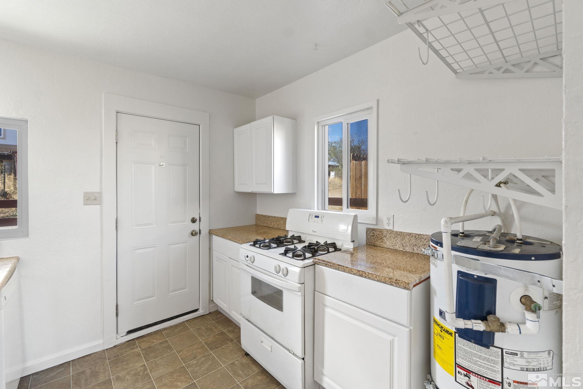 157 Walner Street Reno, NV 89506 - Photo 13 of 21 a kitchen with stainless steel appliances a stove a sink and a refrigerator