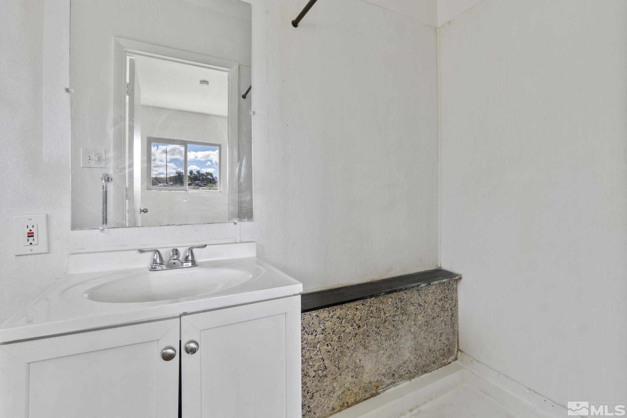 157 Walner Street Reno, NV 89506 - Photo 14 of 21 a bathroom with a sink and a mirror