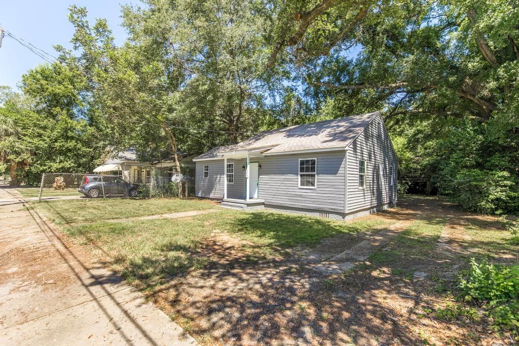 a view of a backyard with large trees