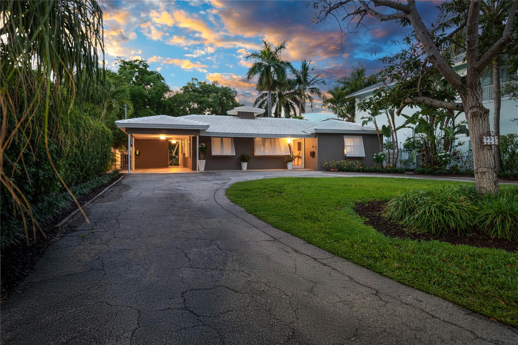 224 North Gordon Road Fort Lauderdale, FL 33301 - Photo 6 of 45 a front view of a house with a yard and garage