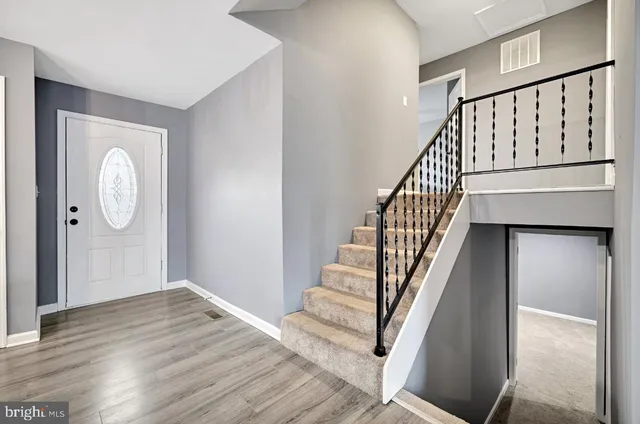 a view of an entryway with wooden floor