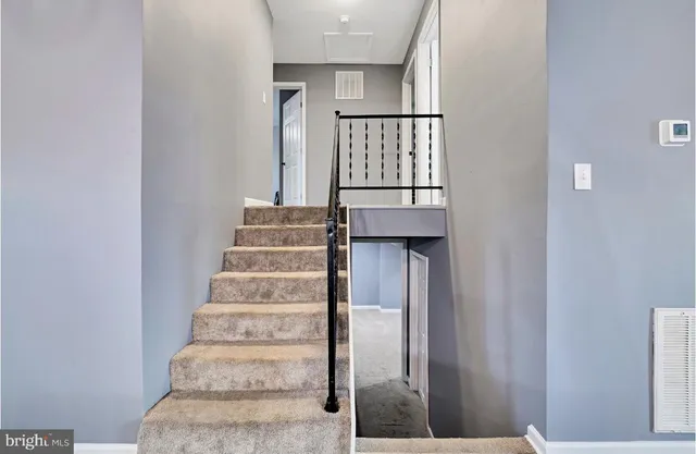 a view of staircase with white walls and windows
