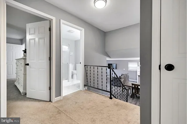 a view of a hallway with paintings on the wall
