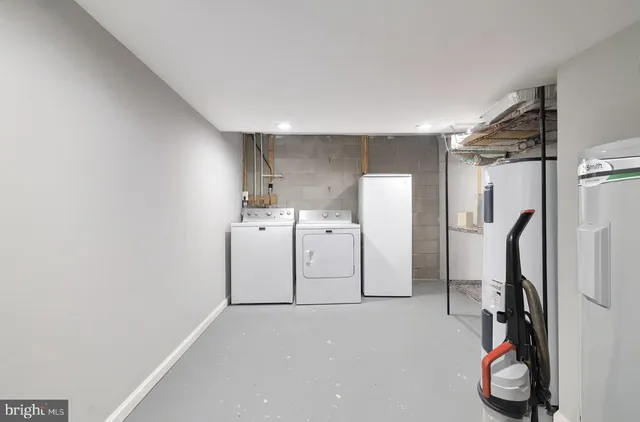 a utility room with multiple dryer and washer