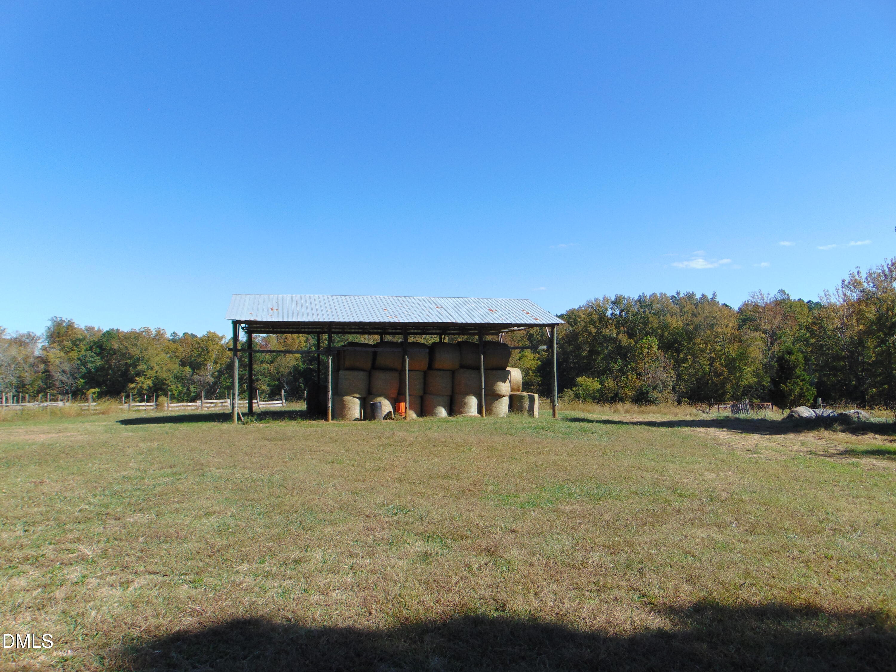 4067 Chewning Road Oxford, NC 27565 - Photo 48 of 82 a view of a large pool with lawn chairs under an umbrella