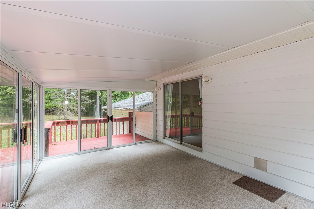 3077 Luli Road Mogadore, OH 44260 - Photo 12 of 34 Unfurnished sunroom with vaulted ceiling