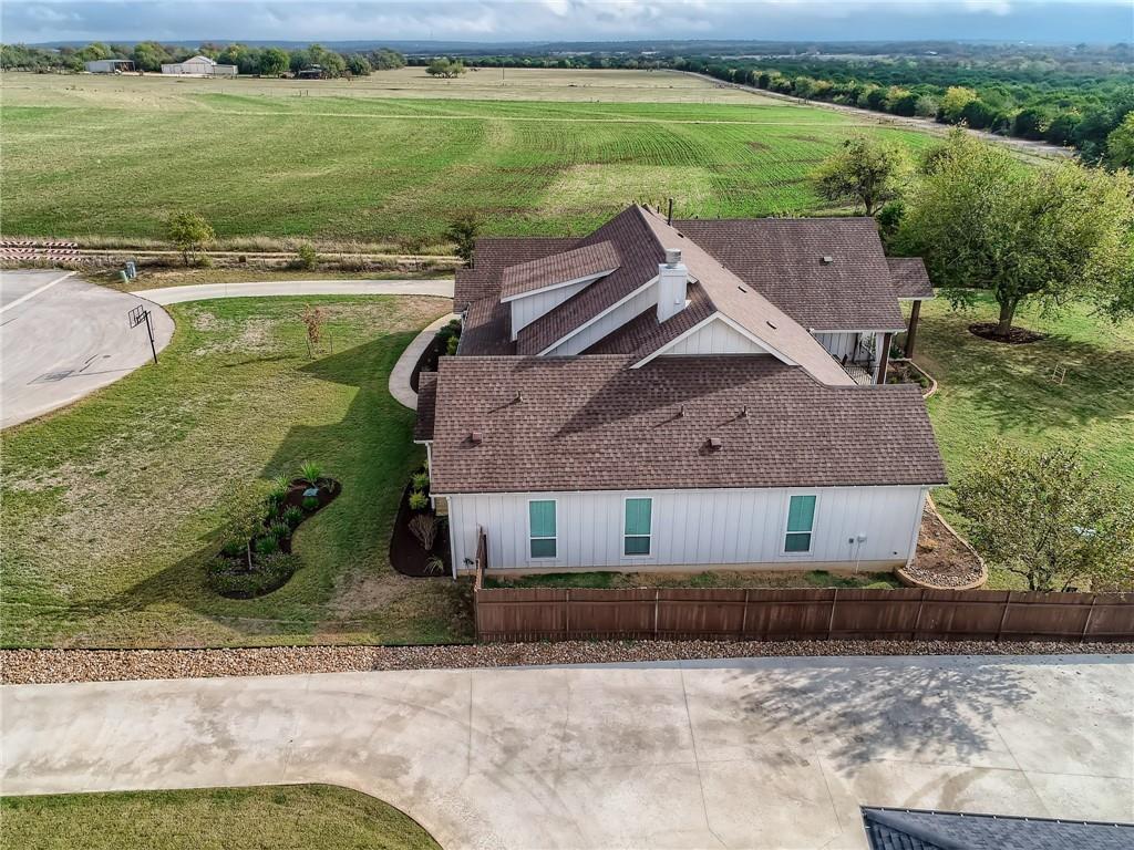 132 Huerta Road Florence, TX 76527 - Photo 39 of 40 An aerial perspective showcases this home's tranquil setting with expansive green fields in the distance.