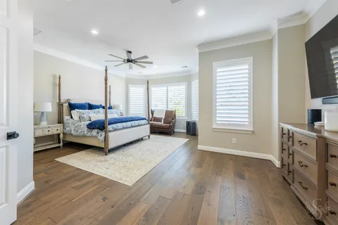 a bedroom with furniture and a flat screen tv
