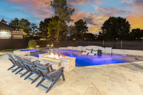 a view of swimming pool with sitting area