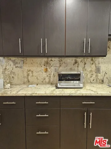 a metallic refrigerator freezer sitting in a kitchen
