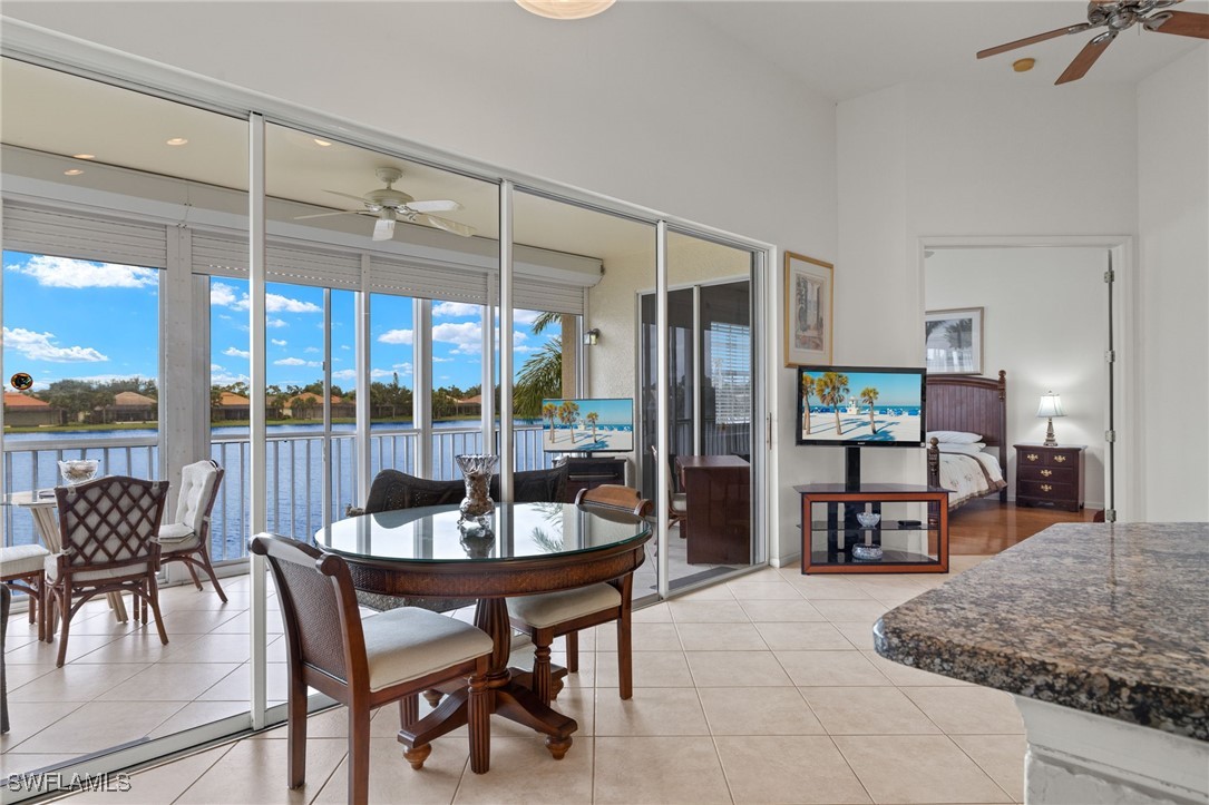 16253 Coco Hammock Way, Unit 201 Fort Myers, FL 33908 - Photo 11 of 34 a dining room with furniture and a floor to ceiling window