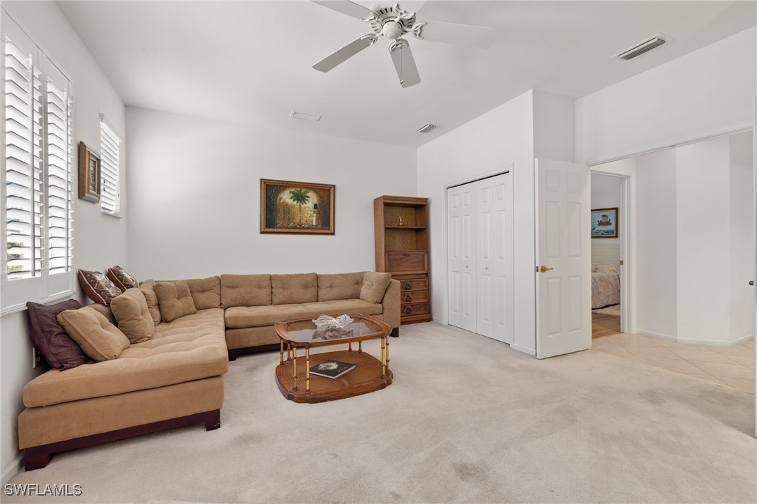 16253 Coco Hammock Way, Unit 201 Fort Myers, FL 33908 - Photo 15 of 34 a living room with furniture and white walls