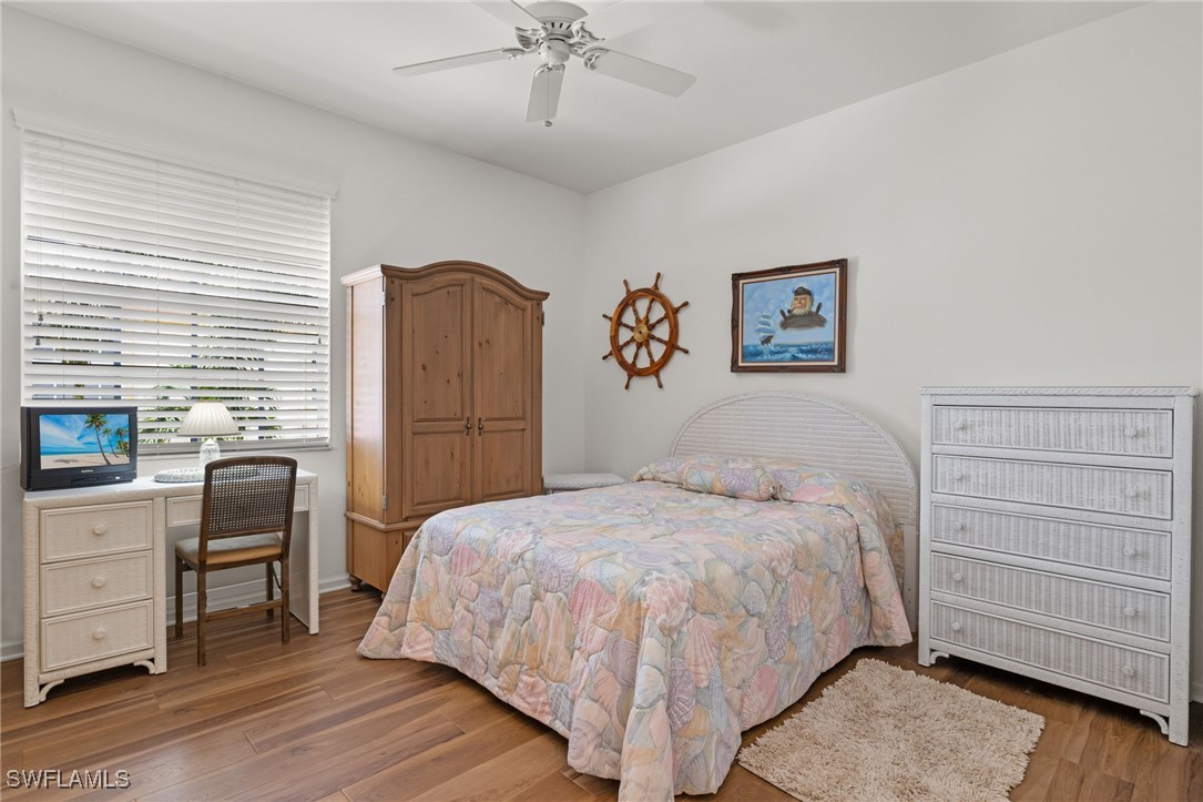 16253 Coco Hammock Way, Unit 201 Fort Myers, FL 33908 - Photo 19 of 34 a bedroom with a bed and a dresser