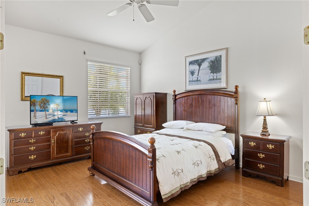 16253 Coco Hammock Way, Unit 201 Fort Myers, FL 33908 - Photo 20 of 34 a bed room with a bed and a tv