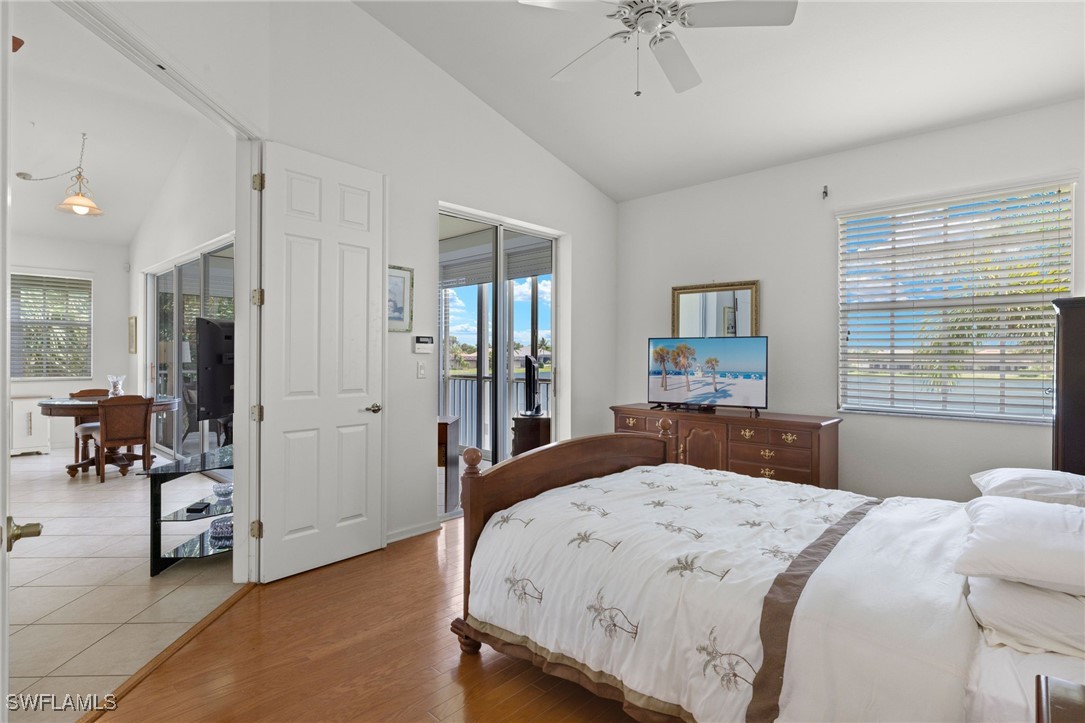 16253 Coco Hammock Way, Unit 201 Fort Myers, FL 33908 - Photo 21 of 34 a bedroom with a bed and large mirror