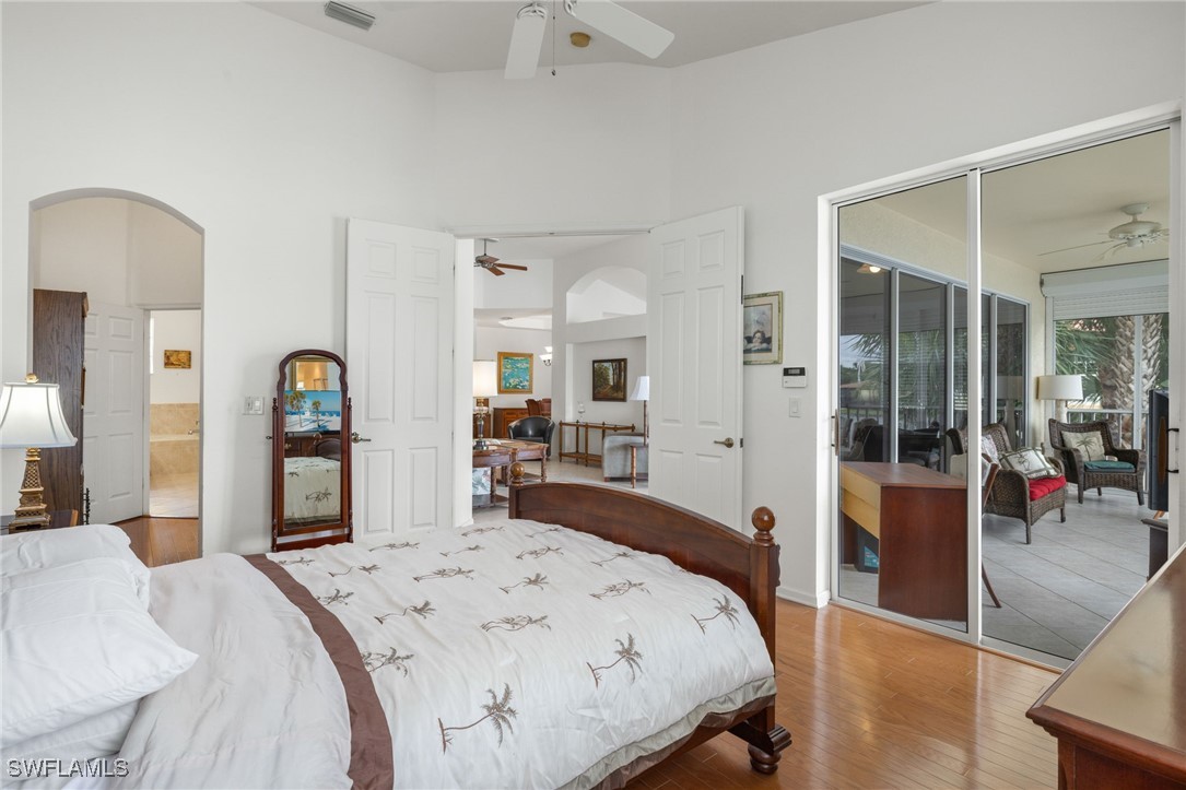 16253 Coco Hammock Way, Unit 201 Fort Myers, FL 33908 - Photo 22 of 34 a bedroom with a bed and a large mirror with a dresser