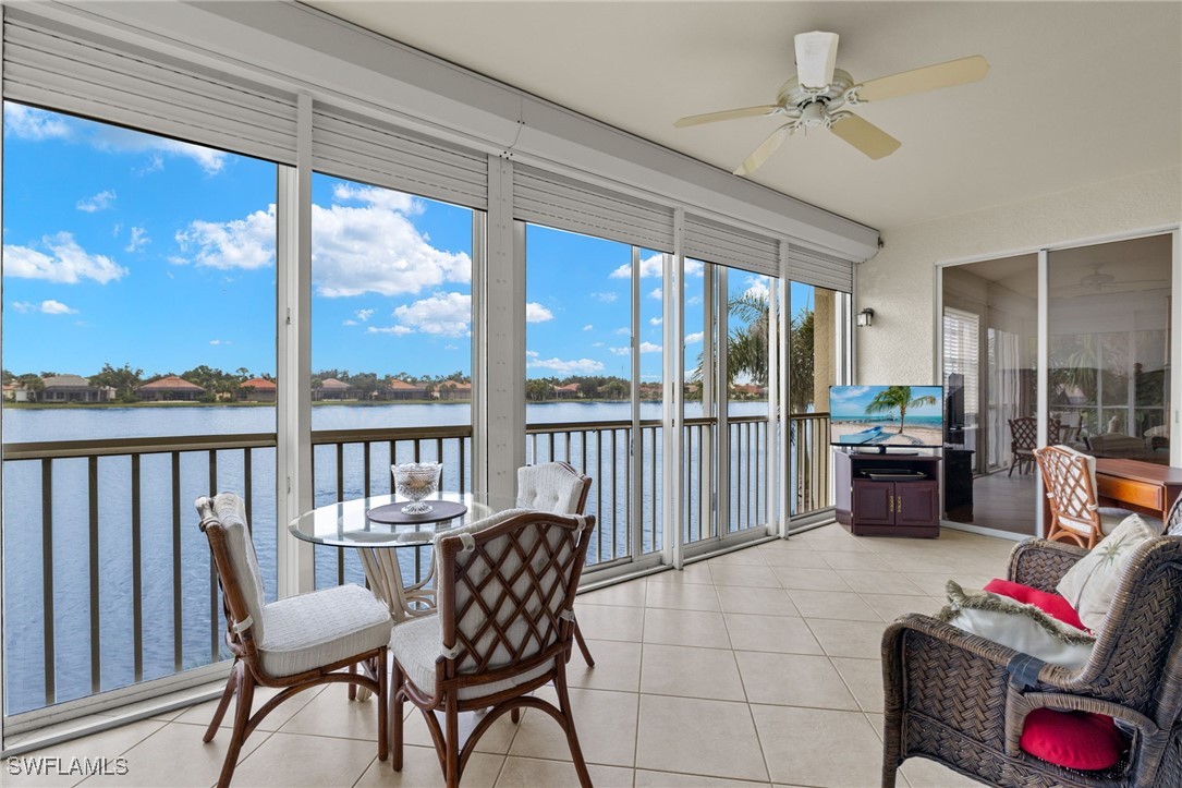 16253 Coco Hammock Way, Unit 201 Fort Myers, FL 33908 - Photo 3 of 34 a living room with furniture and a floor to ceiling window