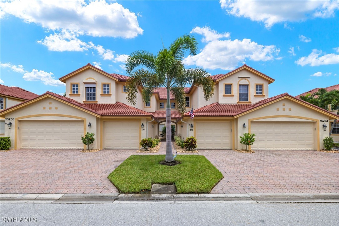 16253 Coco Hammock Way, Unit 201 Fort Myers, FL 33908 - Photo 5 of 34 front view of a house with a yard