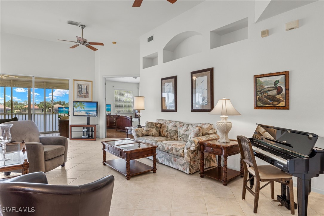 16253 Coco Hammock Way, Unit 201 Fort Myers, FL 33908 - Photo 7 of 34 a living room with furniture and a large window