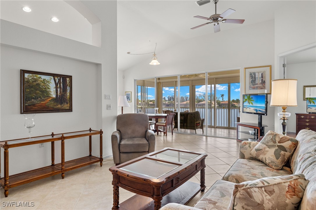 16253 Coco Hammock Way, Unit 201 Fort Myers, FL 33908 - Photo 8 of 34 a living room with furniture a lamp and large window