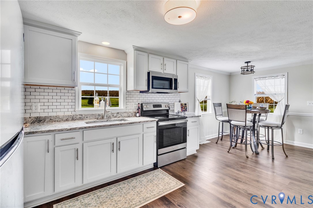36 Bundick Road Lottsburg, VA 22511 - Photo 13 of 50 Kitchen featuring white cabinetry, subway tile bac