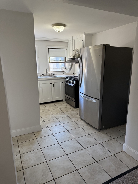 15 Weston Court, Unit 4 Braintree, MA 02184 - Photo 3 of 6 a kitchen with a refrigerator a sink and a stove top oven