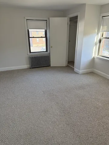 an empty room with a window and doors