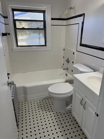 a bathroom with a toilet a sink and a bathtub