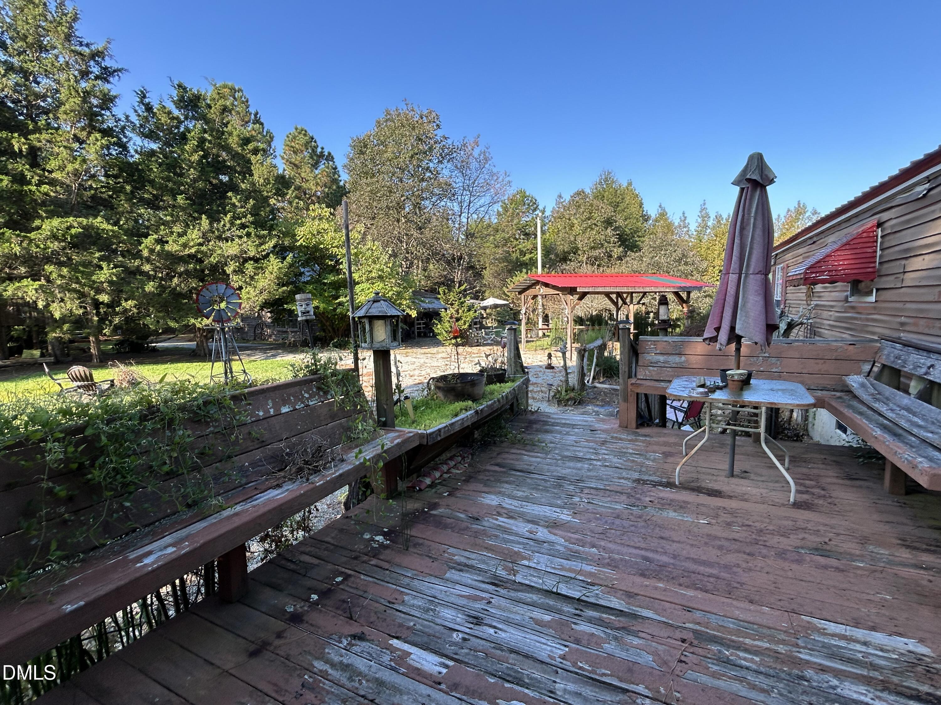 a view of a deck with chairs and wooden fence