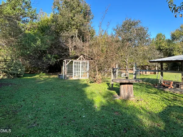 a view of a house with backyard sitting area and garden