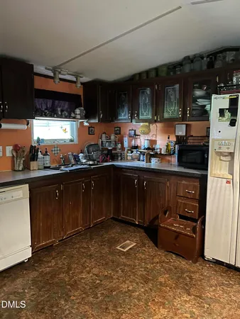 a kitchen with stainless steel appliances granite countertop a sink and cabinets