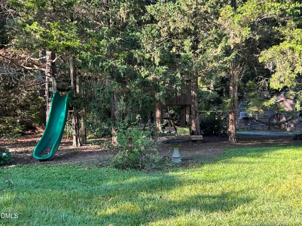 a view of a backyard with swimming pool