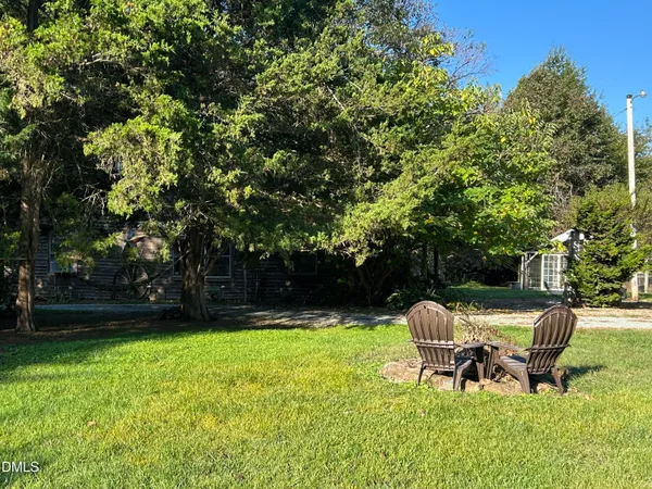 a view of a bench in the garden near a lake
