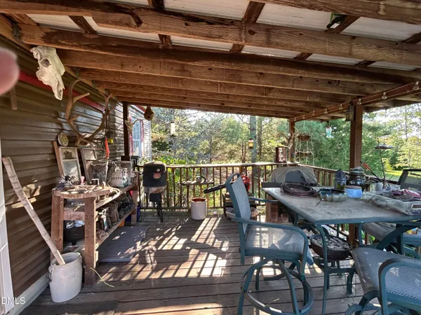 a view of a patio with table and chairs and couches with wooden floor