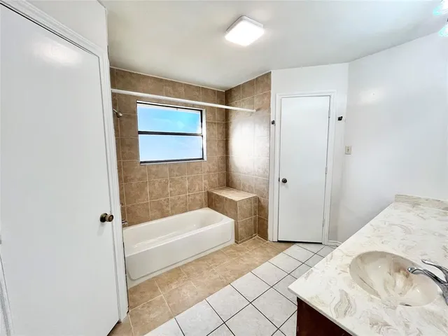 a bathroom with a tub and shower