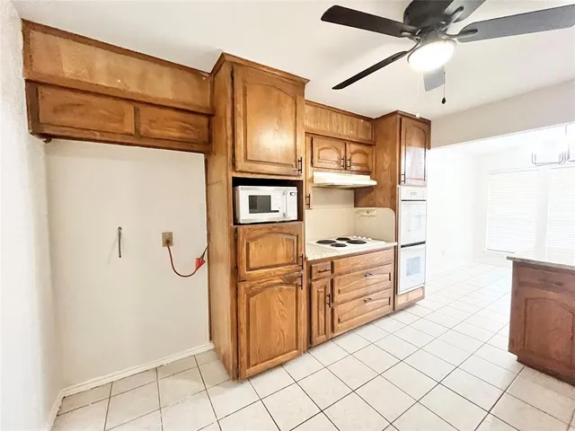 a kitchen with cabinets and stainless steel appliances
