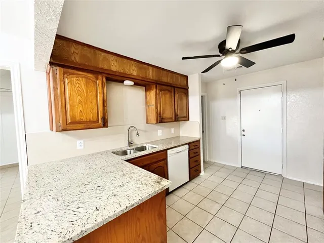 a kitchen with stainless steel appliances granite countertop a sink and cabinets