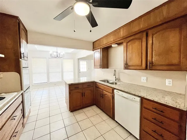 a large kitchen with stainless steel appliances granite countertop a sink and cabinets