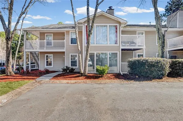 a front view of a house with yard and garage