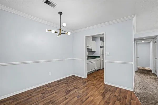 a view of a kitchen with wooden floor