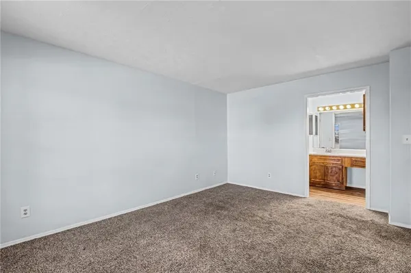 a view of an empty room and fire place