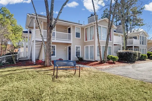 a view of a building with backyard and sitting area