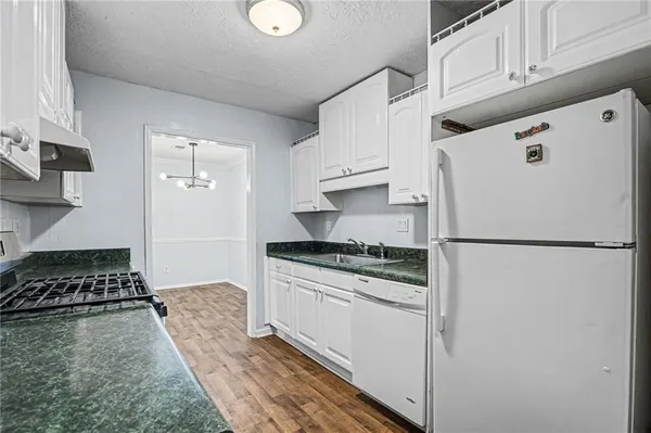 a white refrigerator freezer sitting inside of a kitchen