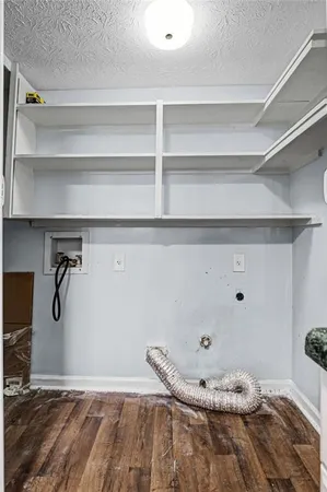 a view of a room with wooden floor