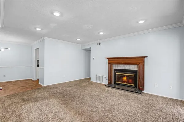 an empty room with a fireplace and washer dryer