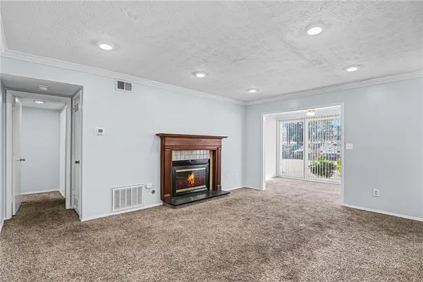 a view of empty room with a fireplace