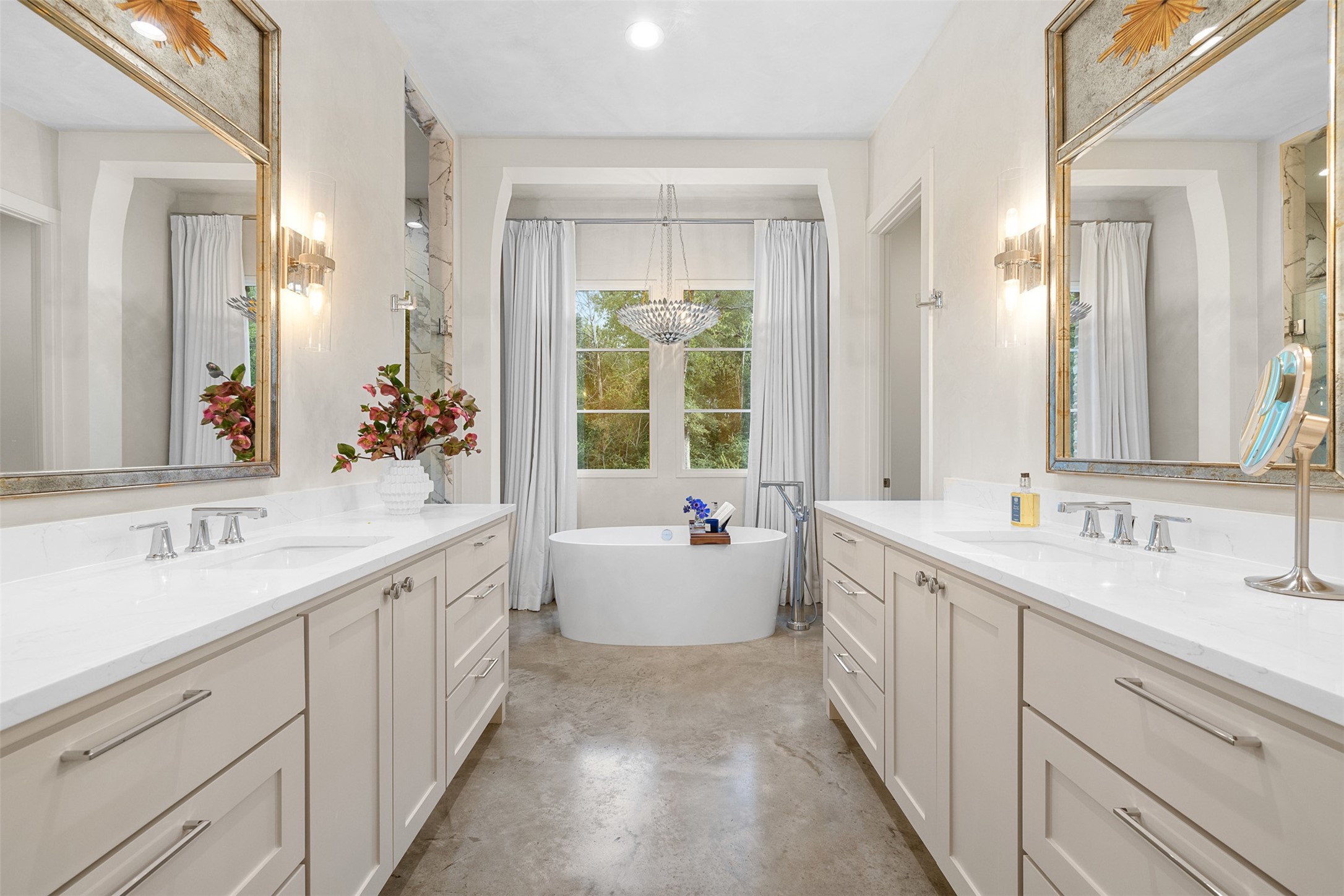 565 Bybee Road Round Top, TX 78954 - Photo 11 of 30 a bathroom with a double vanity sink large mirror and a bathtub