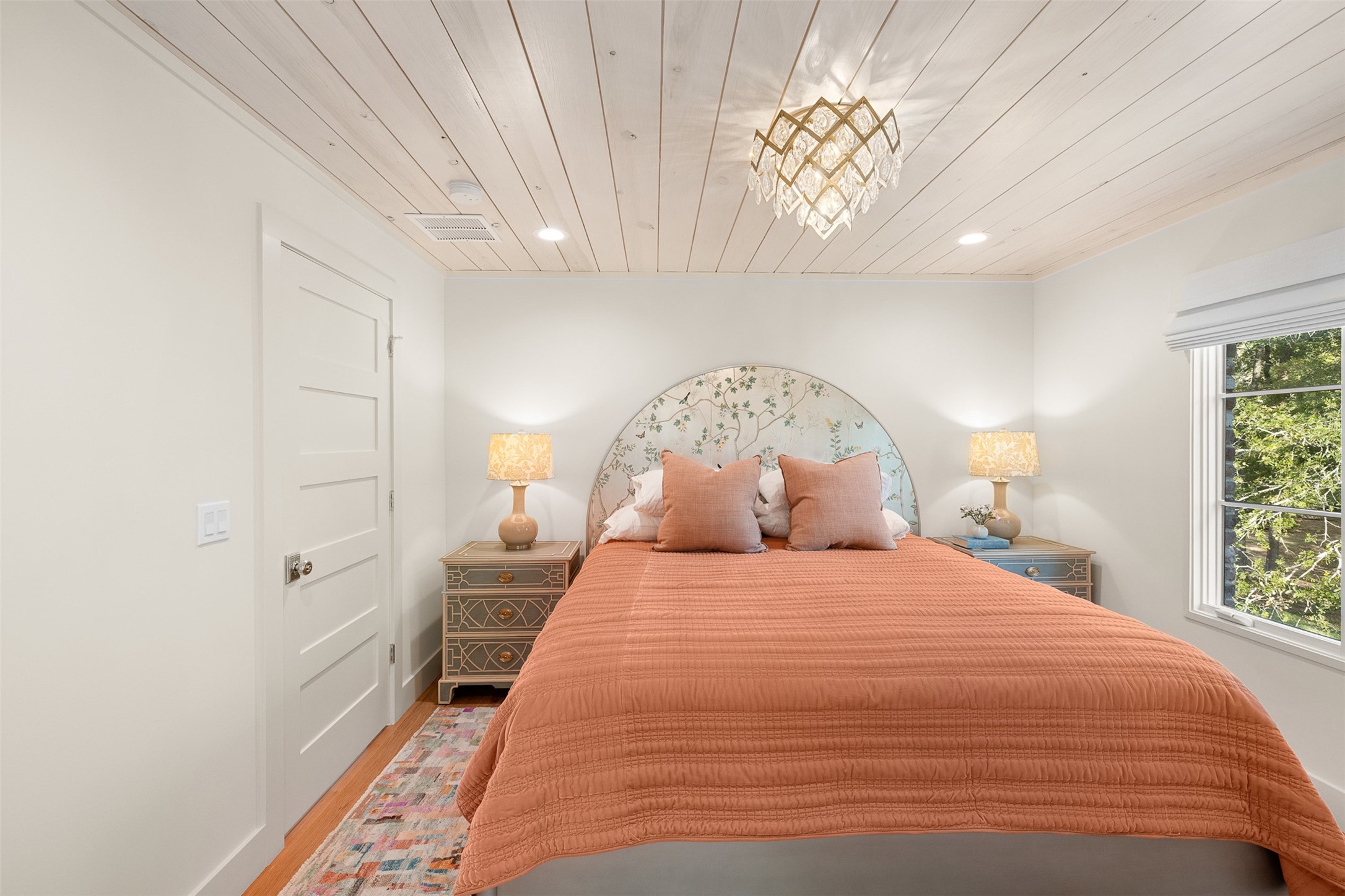 565 Bybee Road Round Top, TX 78954 - Photo 16 of 32 a large bed sitting in a bedroom next to a window and a chandelier